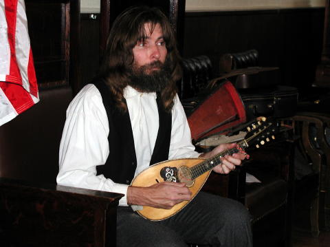Rex Rideout tunes his vintage Mandolin